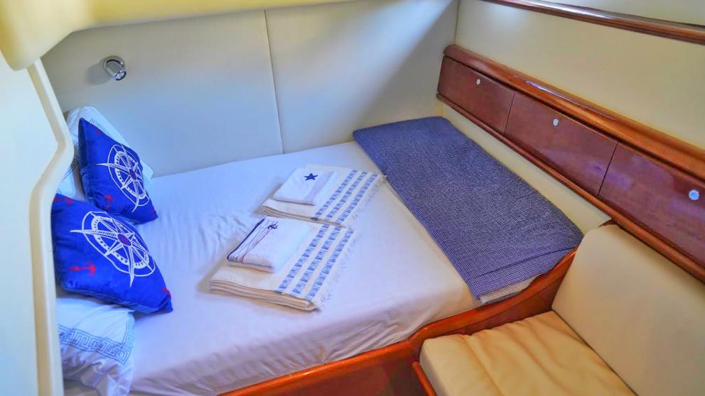 A bed decorated with a marine theme in a cabin on a yacht